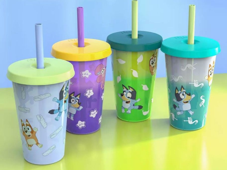 4 plastic tumblers with lids and straws with Bluey decals on them