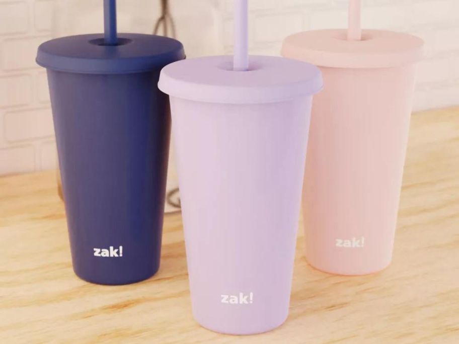 3 plastic tumblers with lids and straws