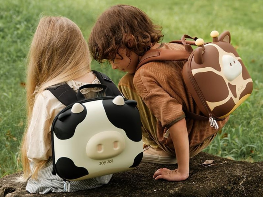 little girl and boy each wearing animal themed toddler backpacks outside
