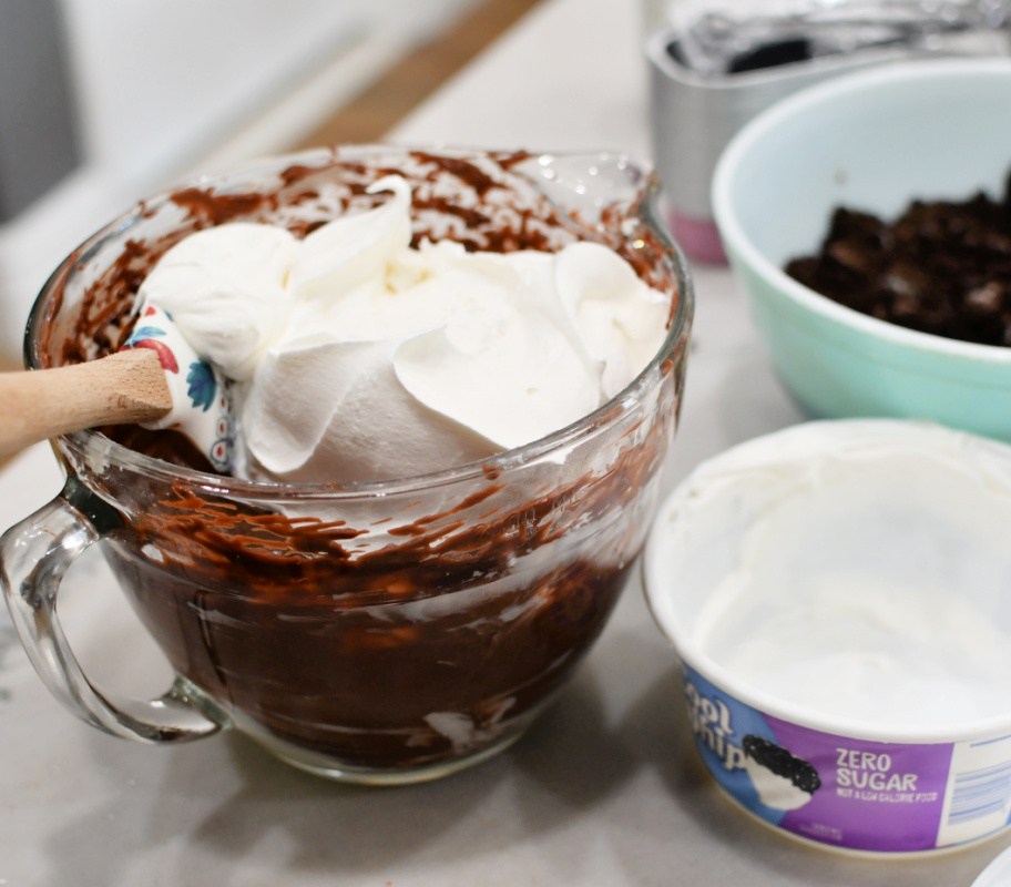 adding cool whip to pudding to create easter dirt cake