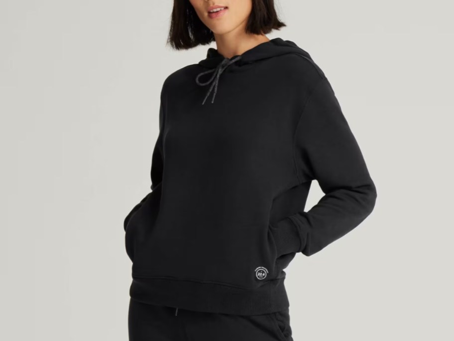 woman wearing a black allbirds hoodie