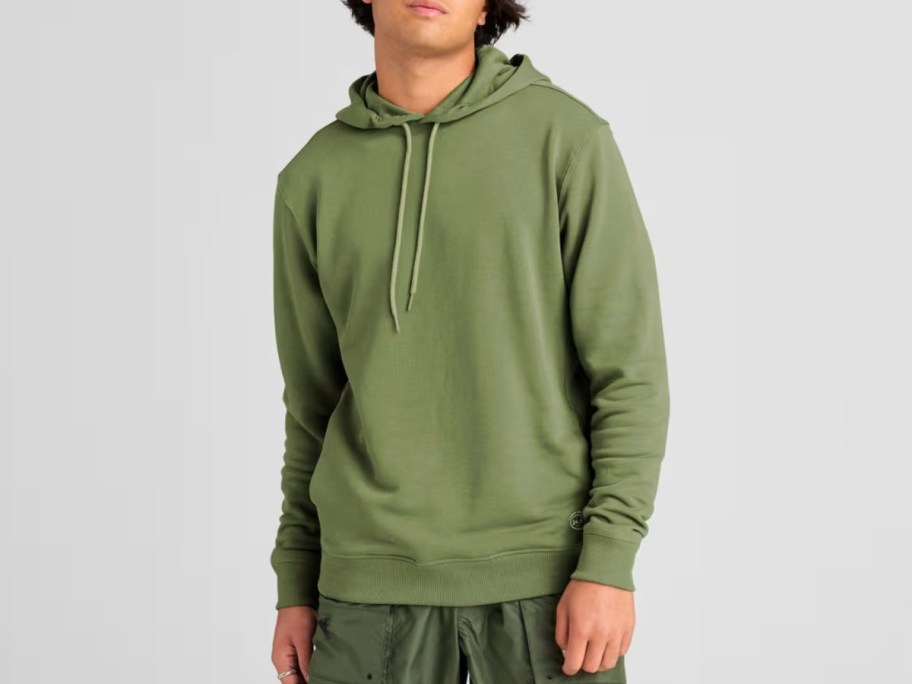 man wearing a green allbirds hoodie