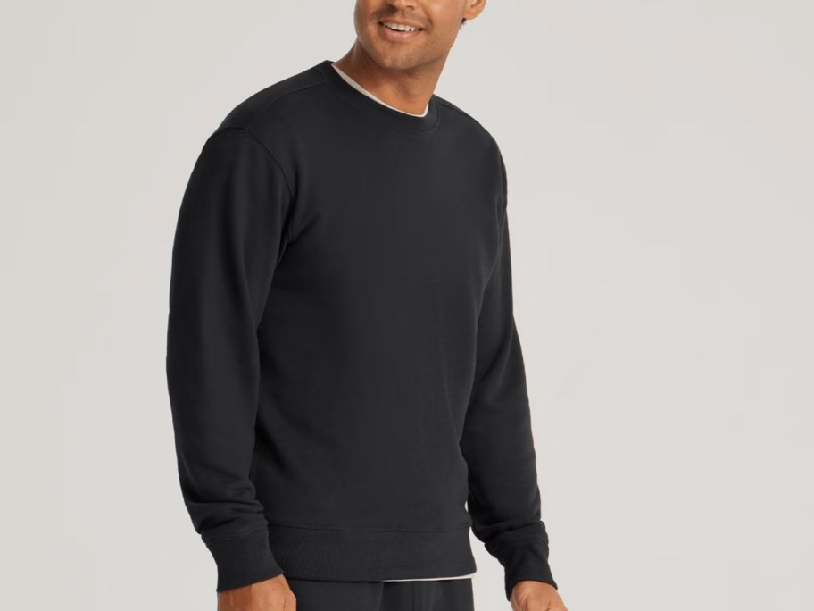 man wearing a black allbirds sweatshirt