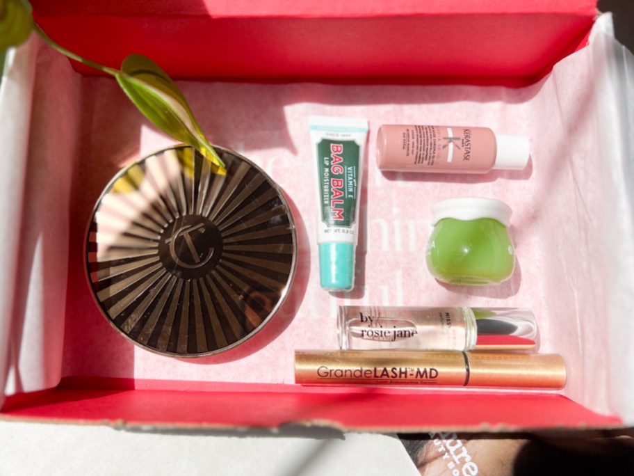 bronzer, perfume oil, lip balm, lash serum and more beauty items in box
