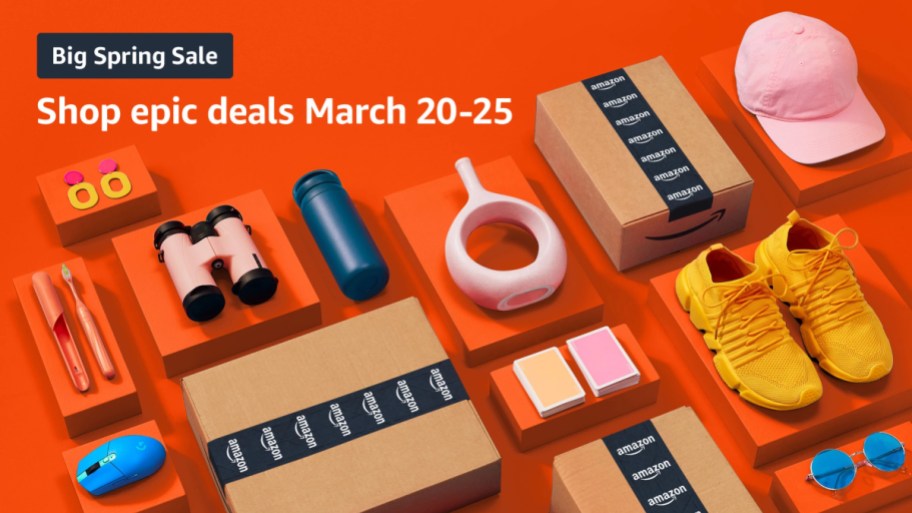 Amazon packages and various products laid out on an orange background