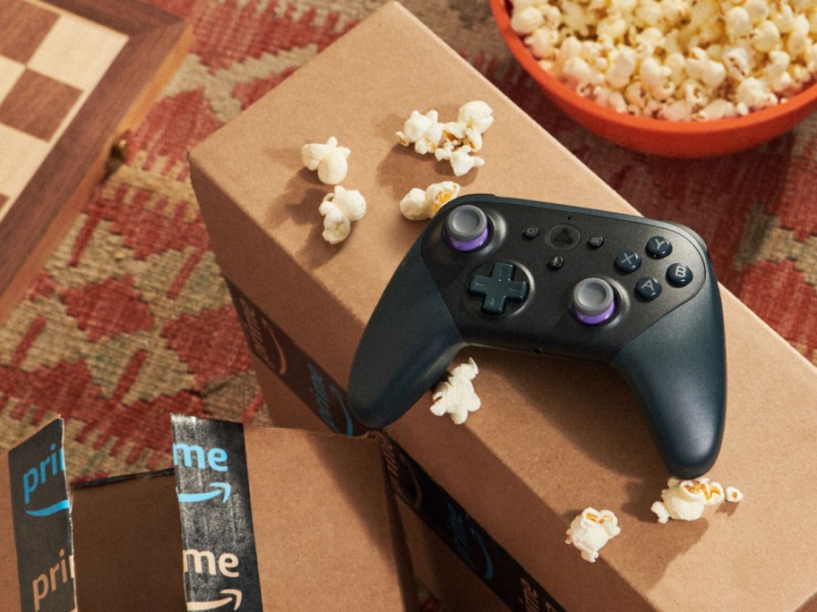 video game controller and popcorn on Amazon boxes