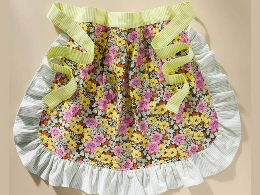 floral half apron with white ruffle trim