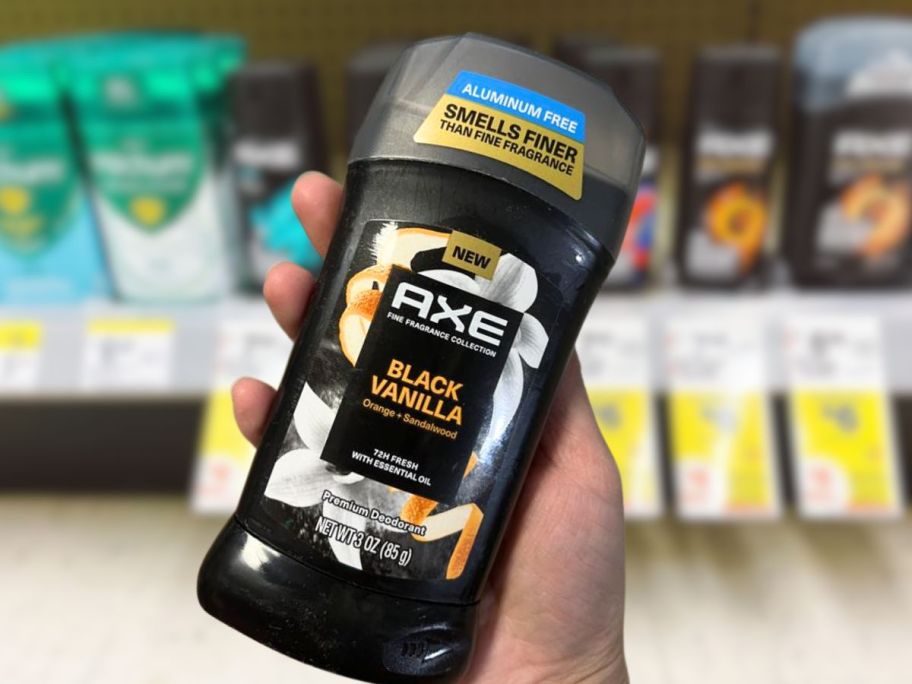 hand holding up axe fine fragrance deodorant 