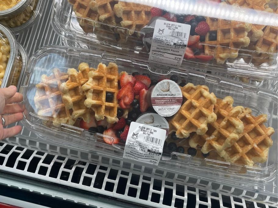 A belgian waffle party tray with 6 belgian waffles topped with fresh strawberries and blueberries
