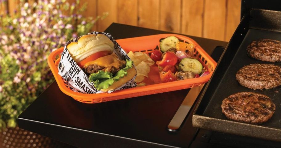 blackstone griddle with burger platter on side table