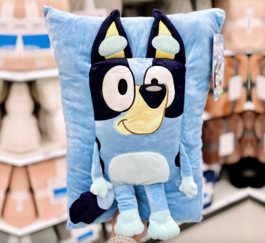 hand holding bluey pillow in store