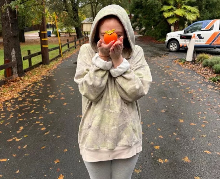 woman wearing oversized camo sweatshirt in road