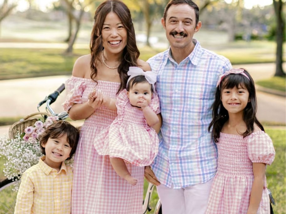 family wearing matching easter clothes in pink, blue and yellow