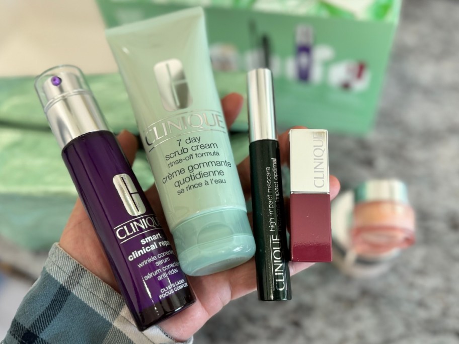 clinique makeup items in hand over counter