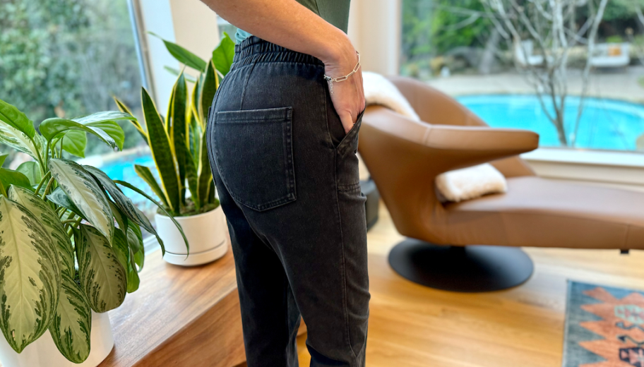 back view of a woman in dark jeans and a green shirt