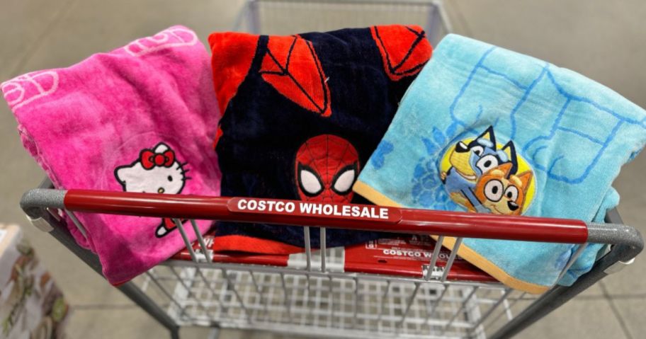 a hello kitty, spiderman and bluey beach towels in a costco cart