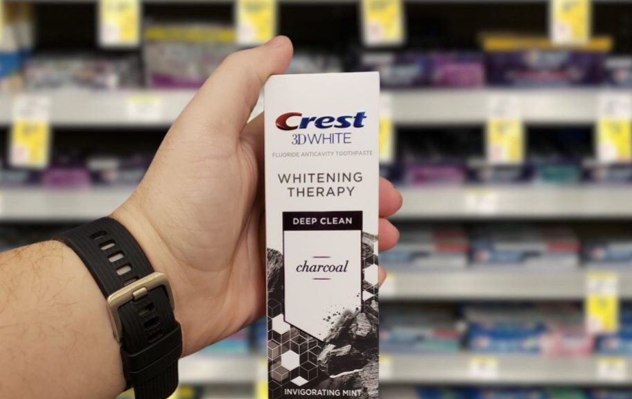 hand holding crest toothpaste in store