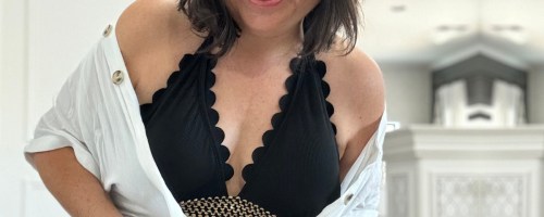woman in black scalloped bathing suit and cover up