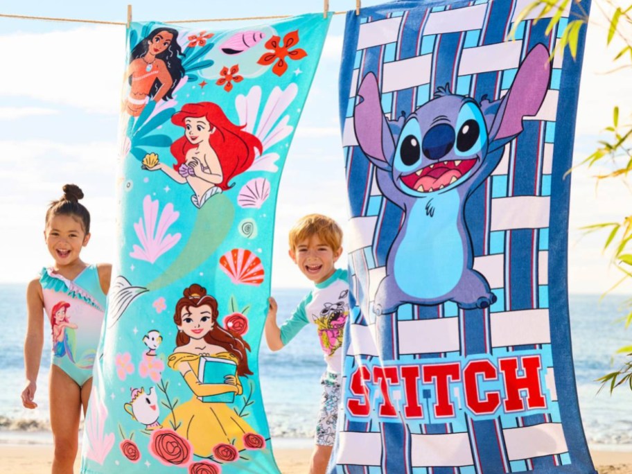 two kids holding up disney towels