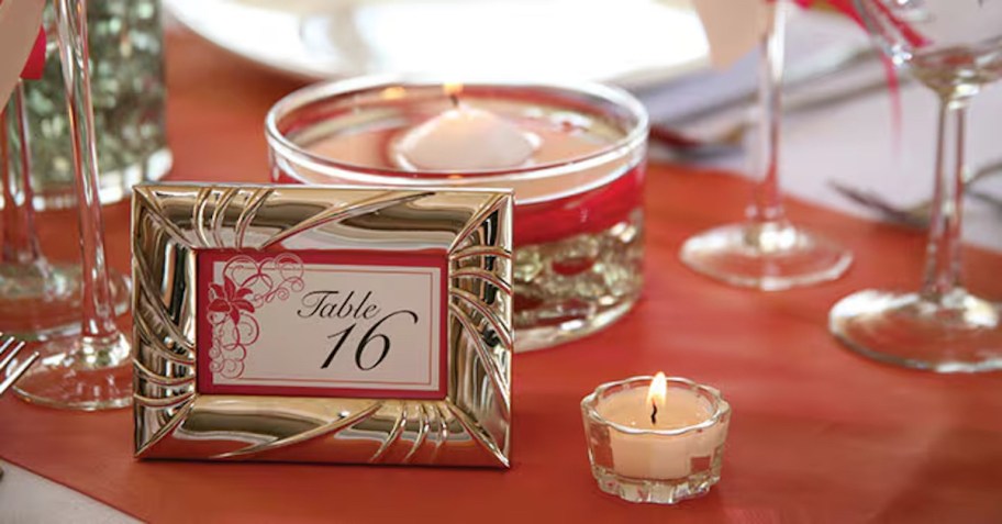 framed table number on table with red tablecloth and dishes