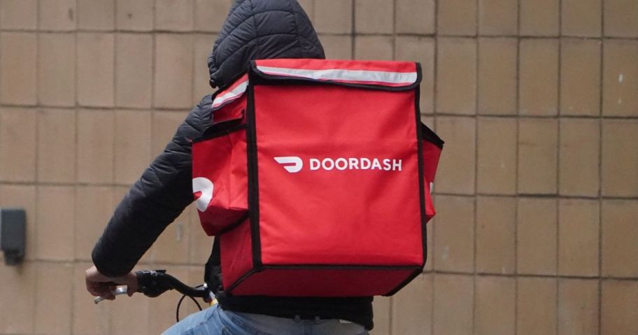 doordasher on bike with doordash backpack on