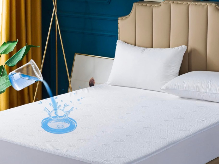white mattress protector on bed with water falling on it