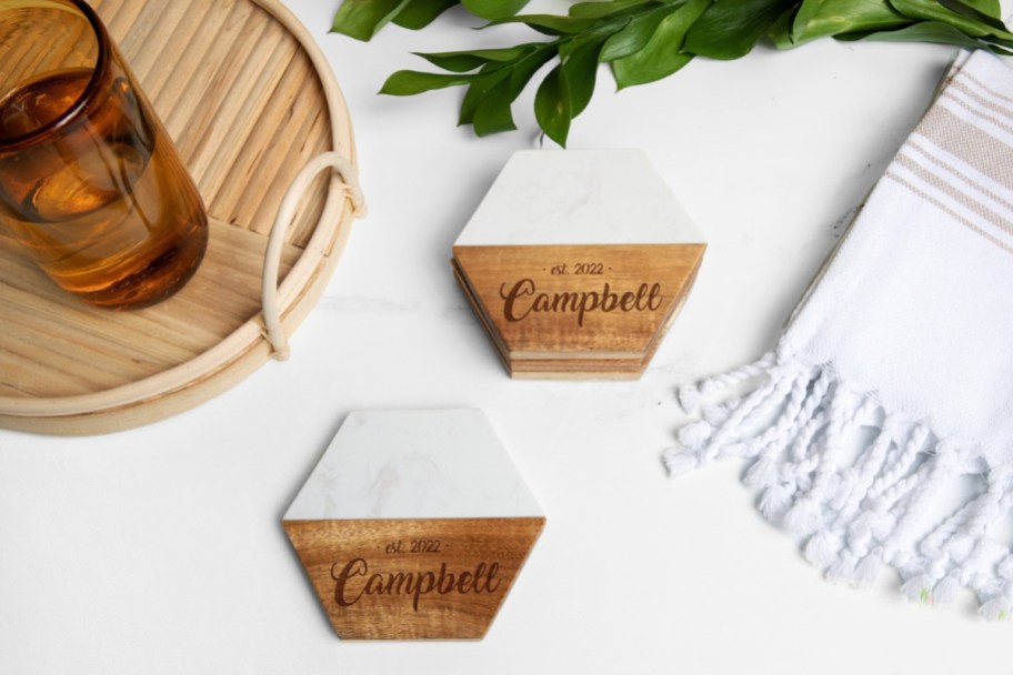 two wood and marble hexagon coasters