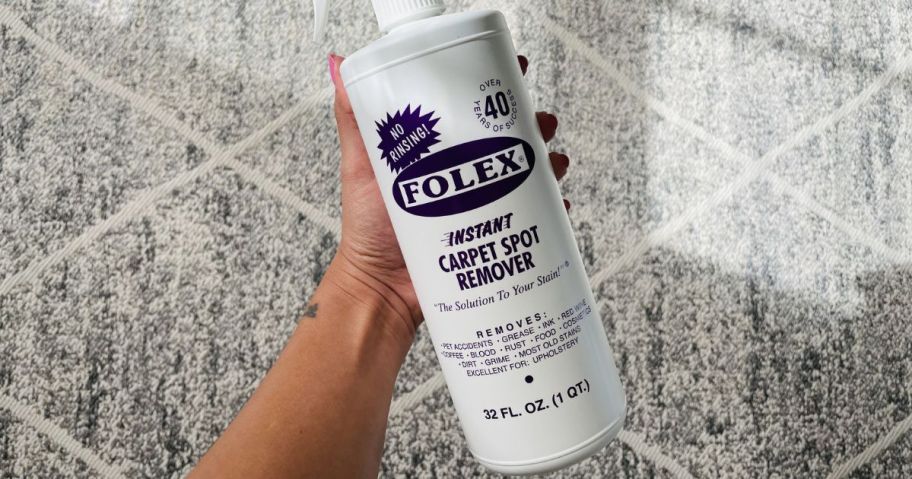 FOLEX Instant Carpet Spot Remover, 32oz being held by hand above a carpet