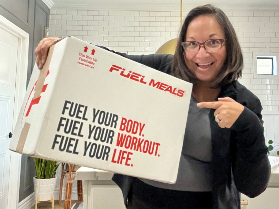 woman holding up fuel meals box