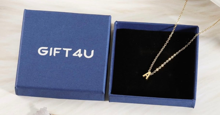 a inital necklace laying in giftbox