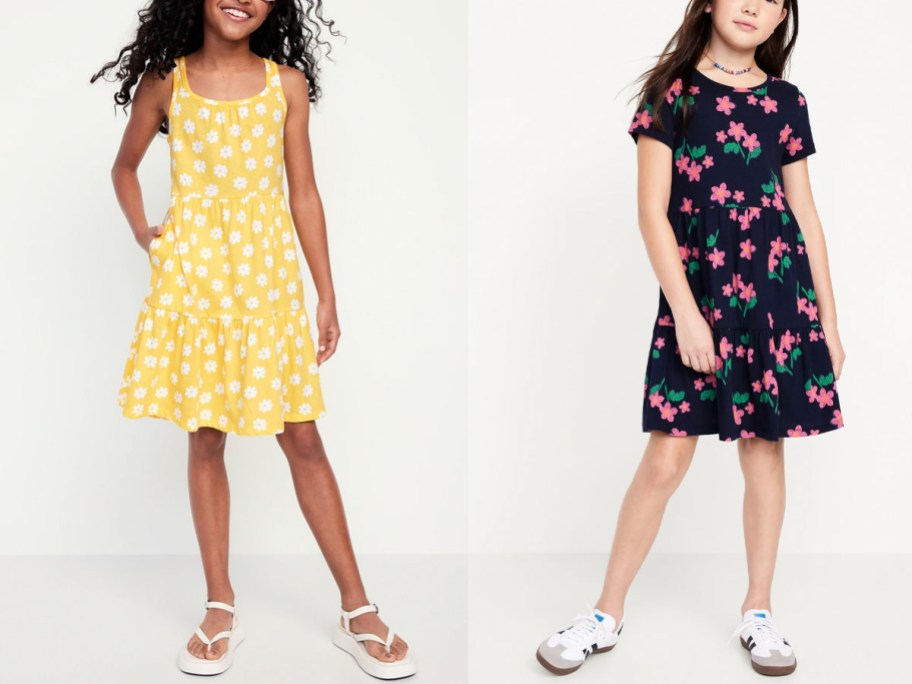 two girls wearing yellow daisy dress and navy floral dresses