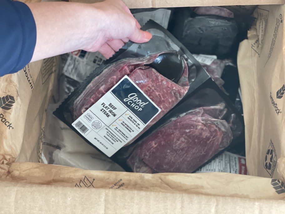 hand grabbing meat out of box