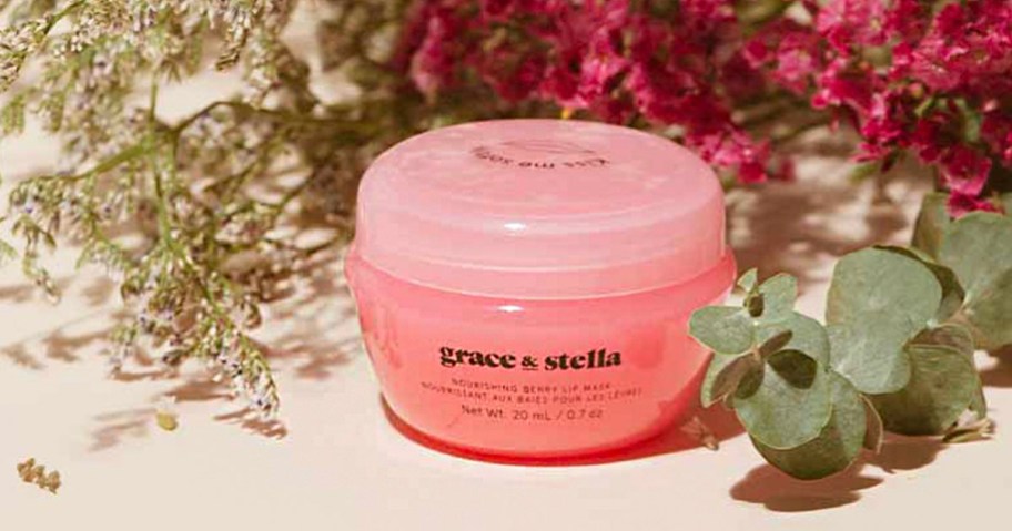 grace and stella lip mask container sitting with flowers