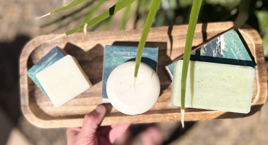 hand. holding bars of soap on a tray displayed outside