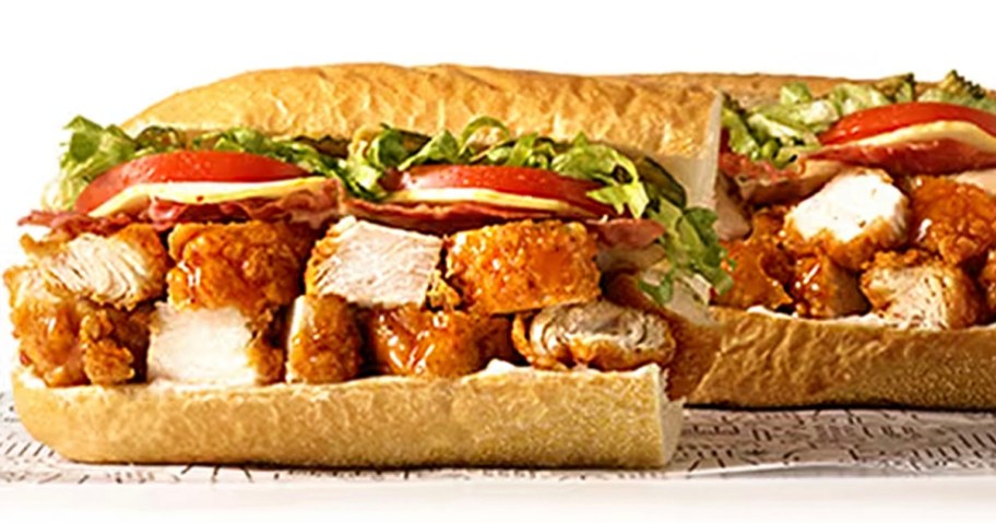 hot honey chicken tender sub cut in half with lettuce and other veggies