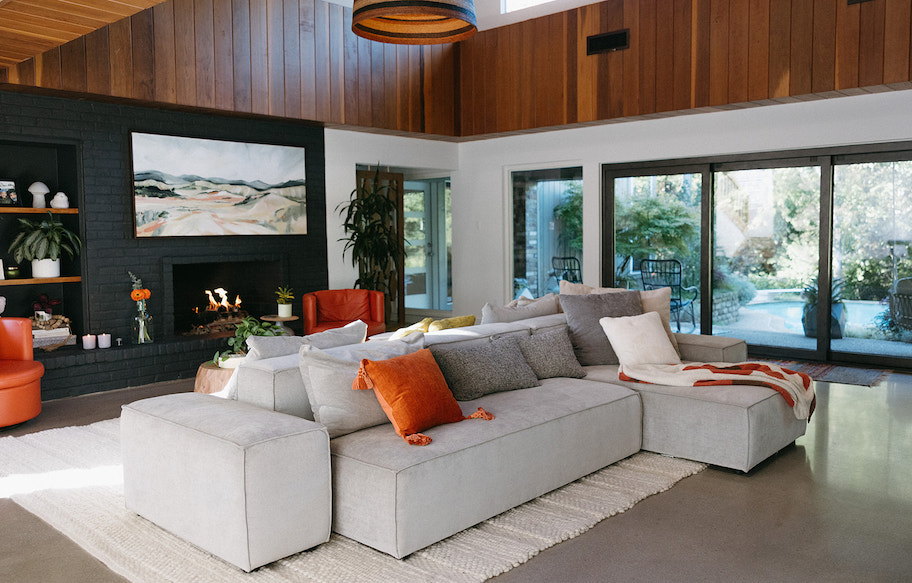 gray sectional in large living room with wood roof