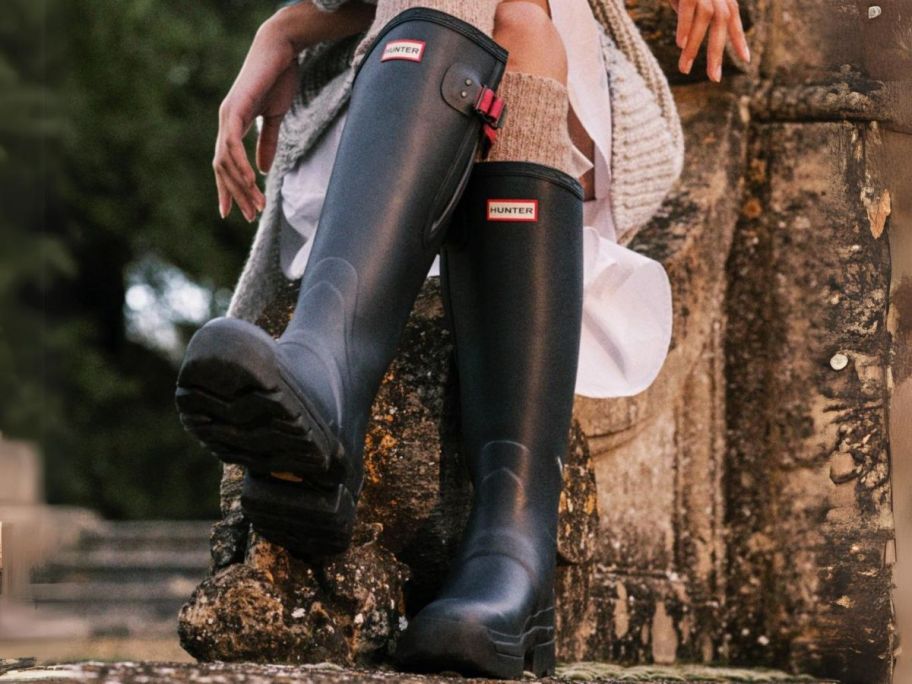 hunter tall boots on women sitting down outside