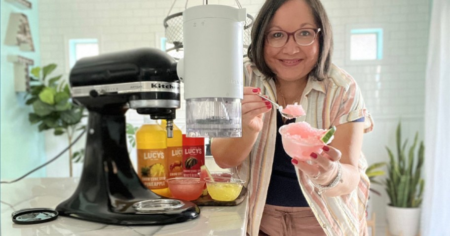 woman holding bowl of frozen ice next to kitchenaid mixer on table