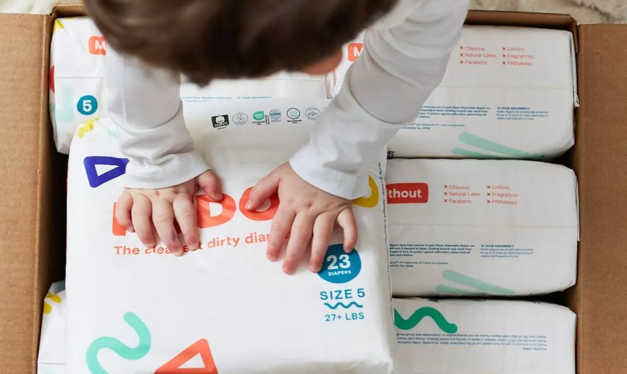 baby hands on box of diapers