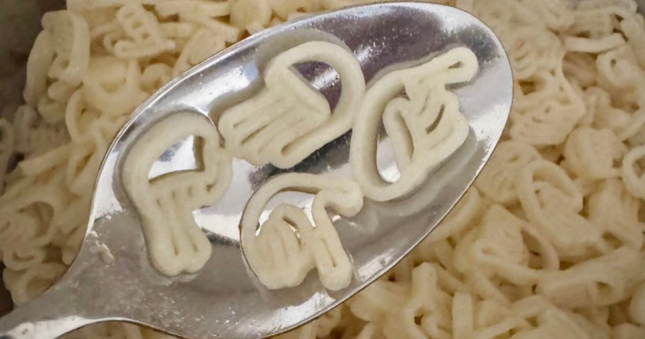 sign language pasta on spoon over bowl of pasta