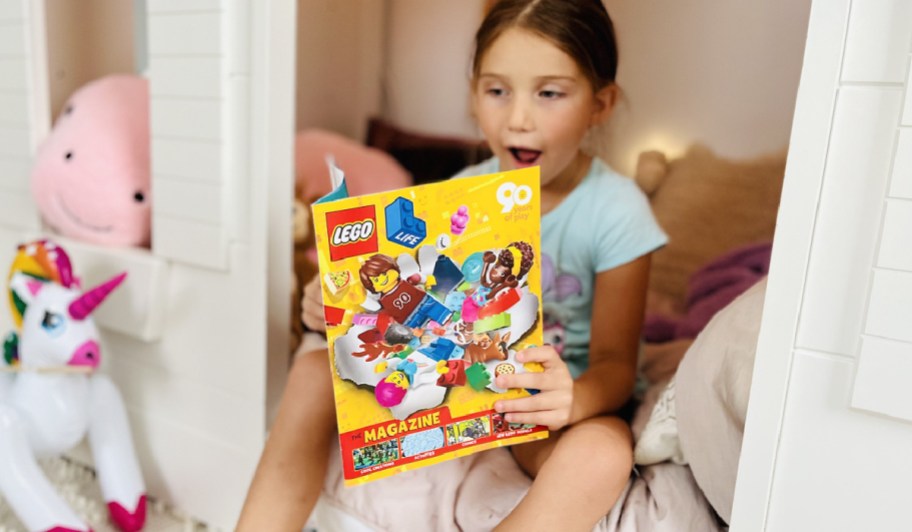 girl reading a lego magazine