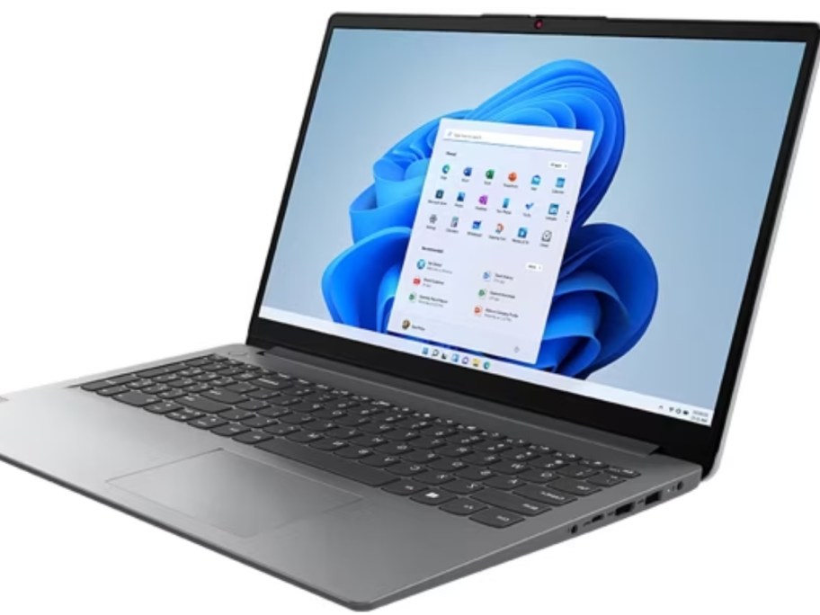 silver Lenovo laptop open showing start screen