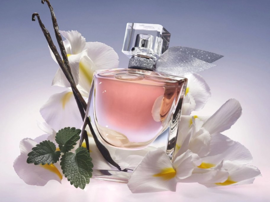 bottle of Lancome La Vie Est Belle L’eveil perfume on flowers and vanilla beans