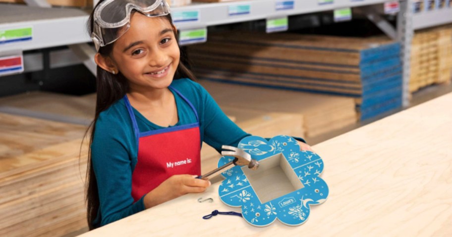 little girl building a blue bird feeder at lowes