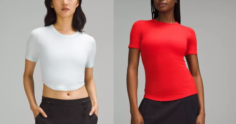 woman wearing light blue crop top and woman wearing red short sleeve shirts