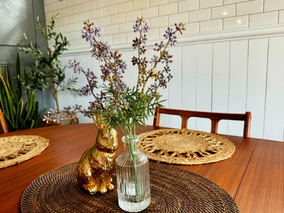 faux wildflower arrangement displayed on a tabletop with spring and Easter items