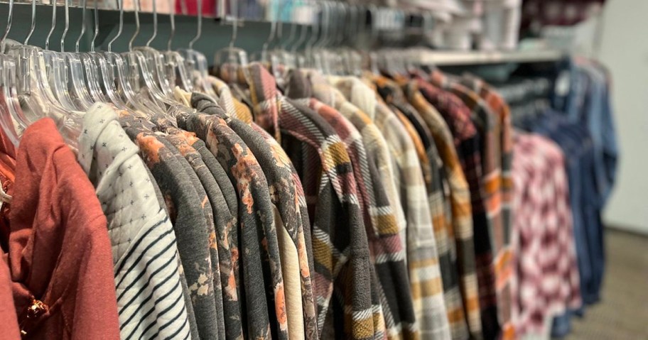 maurices tops hanging on rack in store