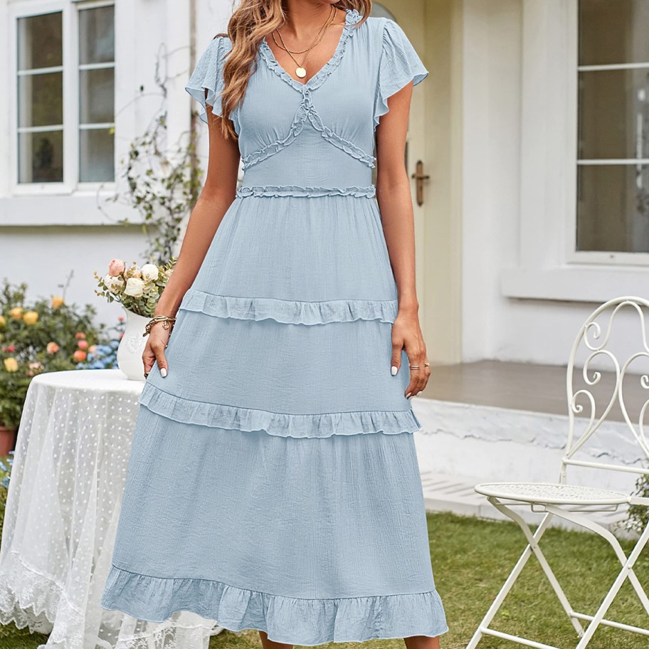 woman wearing a blue dress with ruffles