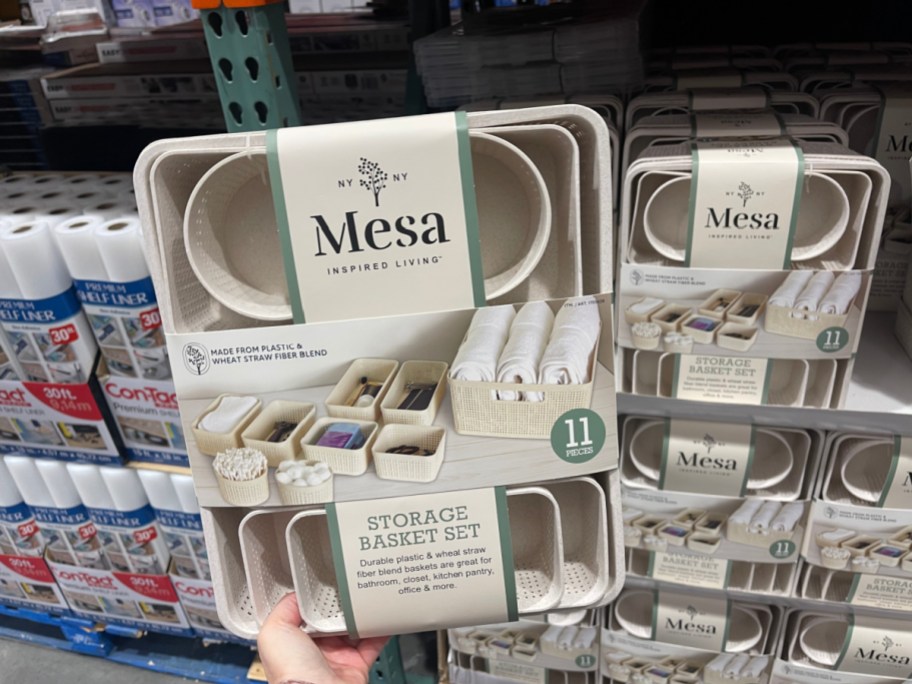 hand holding up a mesa storage basket set in costco store