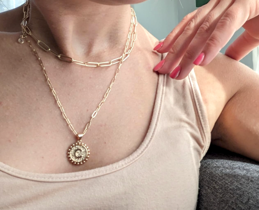 woman wearing monogramed layered initial necklace 
